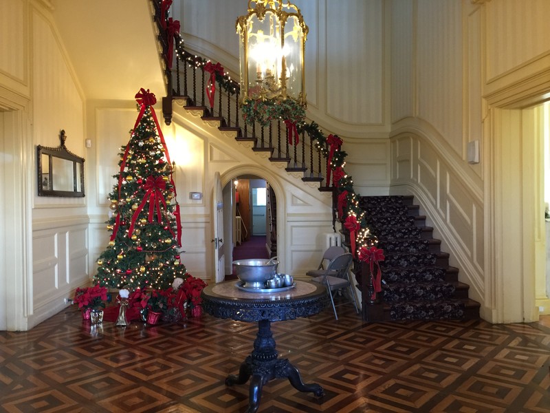 The central hall of the house features a parquet floor and grand staircase. 