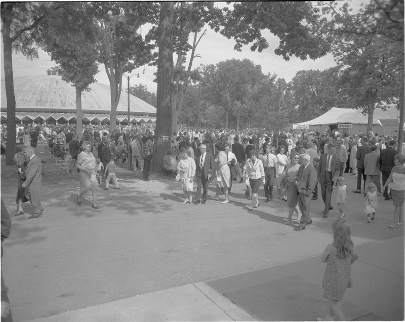 A photo of a Camp Meeting Service with Warner Auditorium in the background