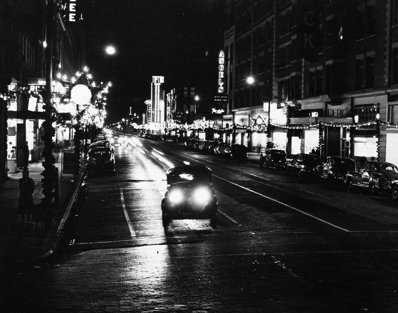 The Tipton's sign lit up at night, on left