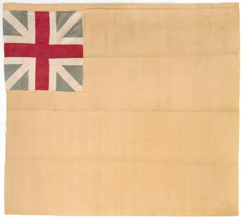 A rectangular flag consisting of a yellow silk ground, pieced from four lengths of fabric sewn horizontally along selvedge edges. In the upper left corner, a British union canton sewn to the yellow silk, offset three inches from the top edge, pieced together of plain weave white and blue silk, with red silk brocade central cross. A pole sleeve on the left edge of the flag has been folded underneath.