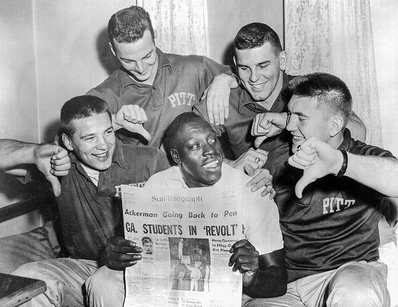 Bobby Grier is surrounded by his supportive teammates. Grier's upcoming presence in the Sugar Bowl sparked protest from Georgia's Governor, Marvin Griffin, Jr. Griffin was subsequently chided in the media and by Georgia Tech students. 