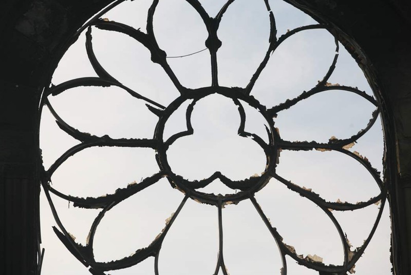 Ruined rose window above the entrance of the 1899 church.