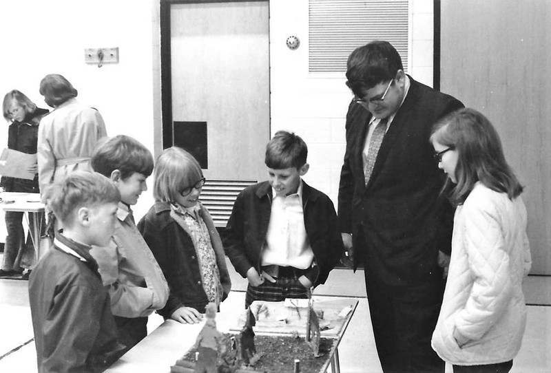 Mr. Lundgren, of Barron, examines a student's display during the 1968 Junior Historian competition at Woodland School in Barron, Wisconsin. The Barron County Historical Society aided in organizing and hosting this event.