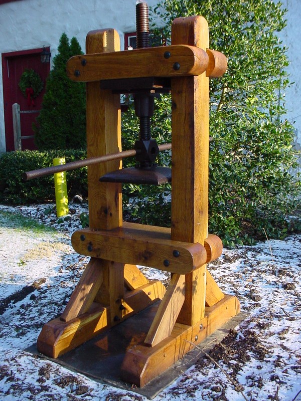 Original iron paper press in a reproduction wooden frame.