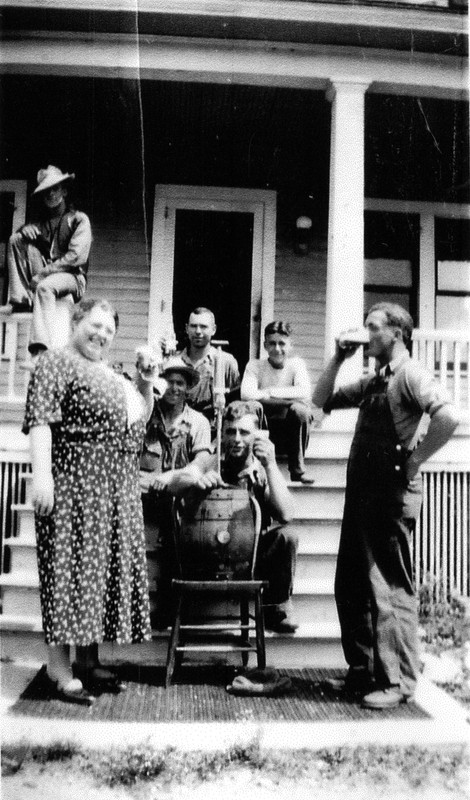 Farm workers enjoy a cold beer after a long day, c. 1930s.