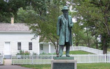 A statue of John H. Stevens in front of the house