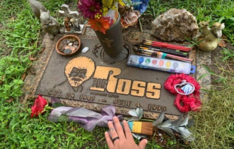 This image shows the love many still have for the late Bob Ross, and the gifting of art supplies of his grave.