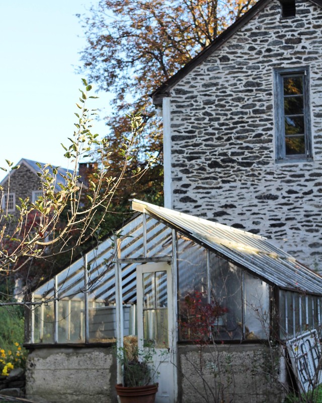 The 1914 greenhouse in front of the 1790s coach house