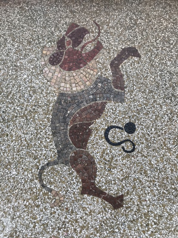 An image of a gray and red lion formed from small tiles.