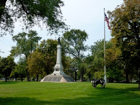 The Confederate Mound at Oak Woods is surrounded by cannons and has an American flag flying over it.