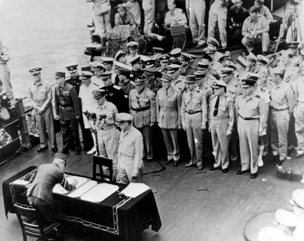 The Japanese delegation prepare to sign the official documents ending World War II before U.S. general Douglas MacArthur