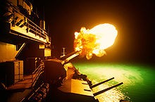 The USS Missouri firing her guns at night