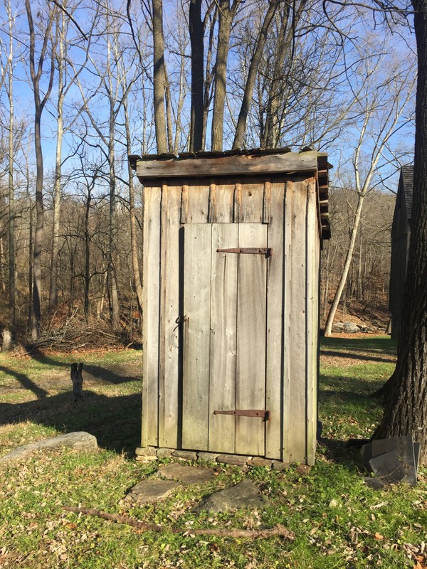 Image of a small wooden structure with a door on the front.