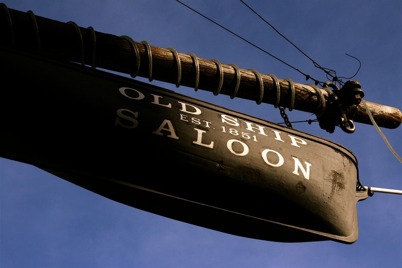 The Old Ship Saloon (built in 1851) was originally opened in the hull of a sailing ship, the Arkansas. The hull of this ship is now buried below paved city streets, but the saloon still operates in at street level in a building at the same spot