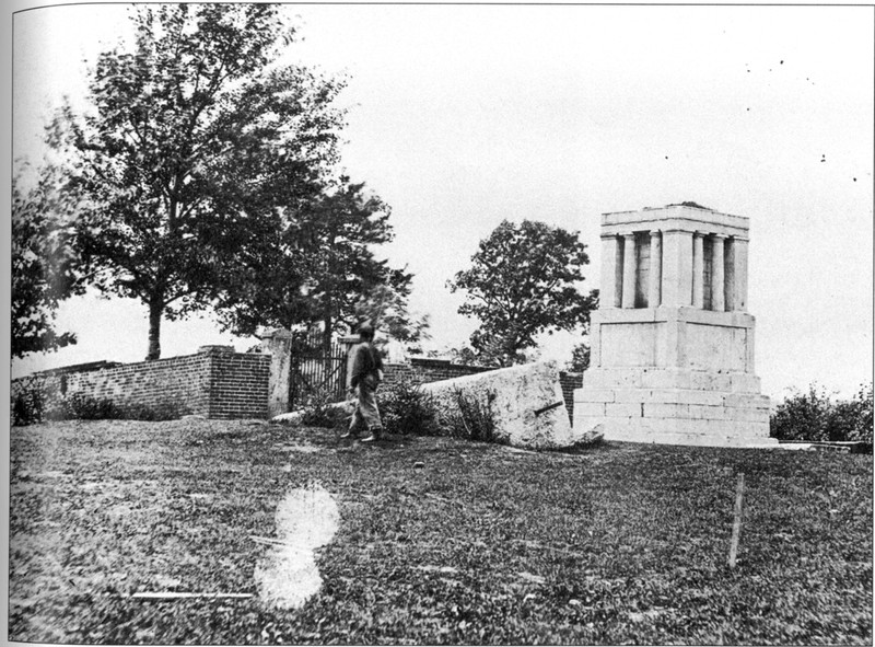 A soldier on guard over the incomplete monument in 1865