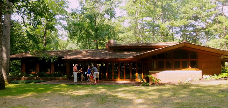 The back or private side of the home with its large plate-glass windows and doors providing a connection to the outside.
