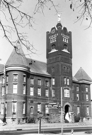 A black and white photo of an old building.