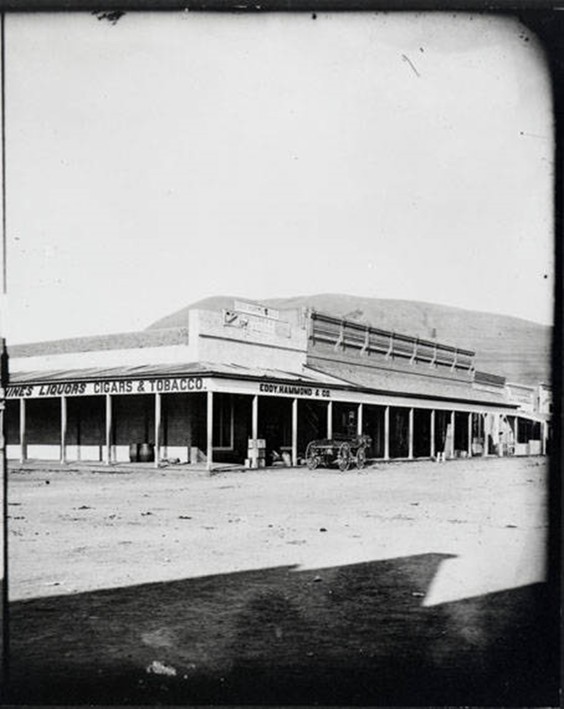 View of Eddy, Hammond & Company Store in Missoula, Montana. Store later called Missoula Mercantile about 1885. Mount Jumbo partially visible in the background. Courtesy of Mtmemory.org.