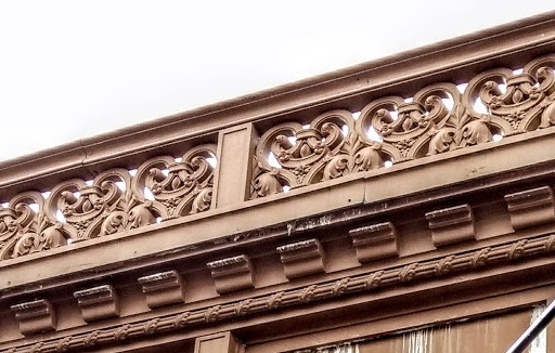 Arabesque frieze and bracketed cornice detail