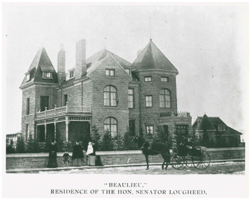 Black and white image of sandstone mansion