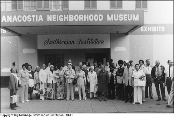 An early photo of the museum, then named the Anacostia Neighborhood museum, with patrons standing outside it.