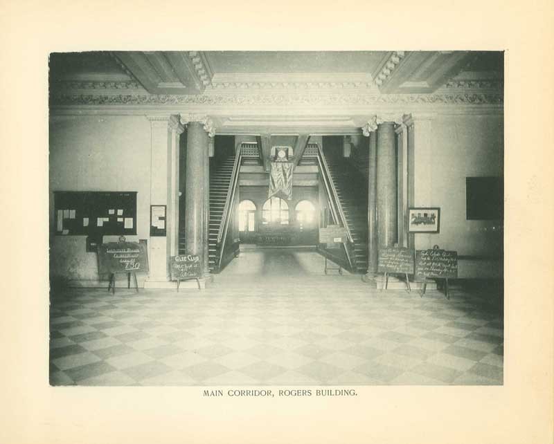 Dual stairways frame large arched windows. 