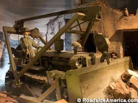 Exhibit of an Army Engineer bulldozing rubble