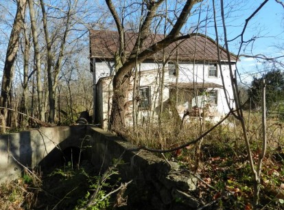 Mill race connecting to flume; creamery addition is visible in front of larger mill