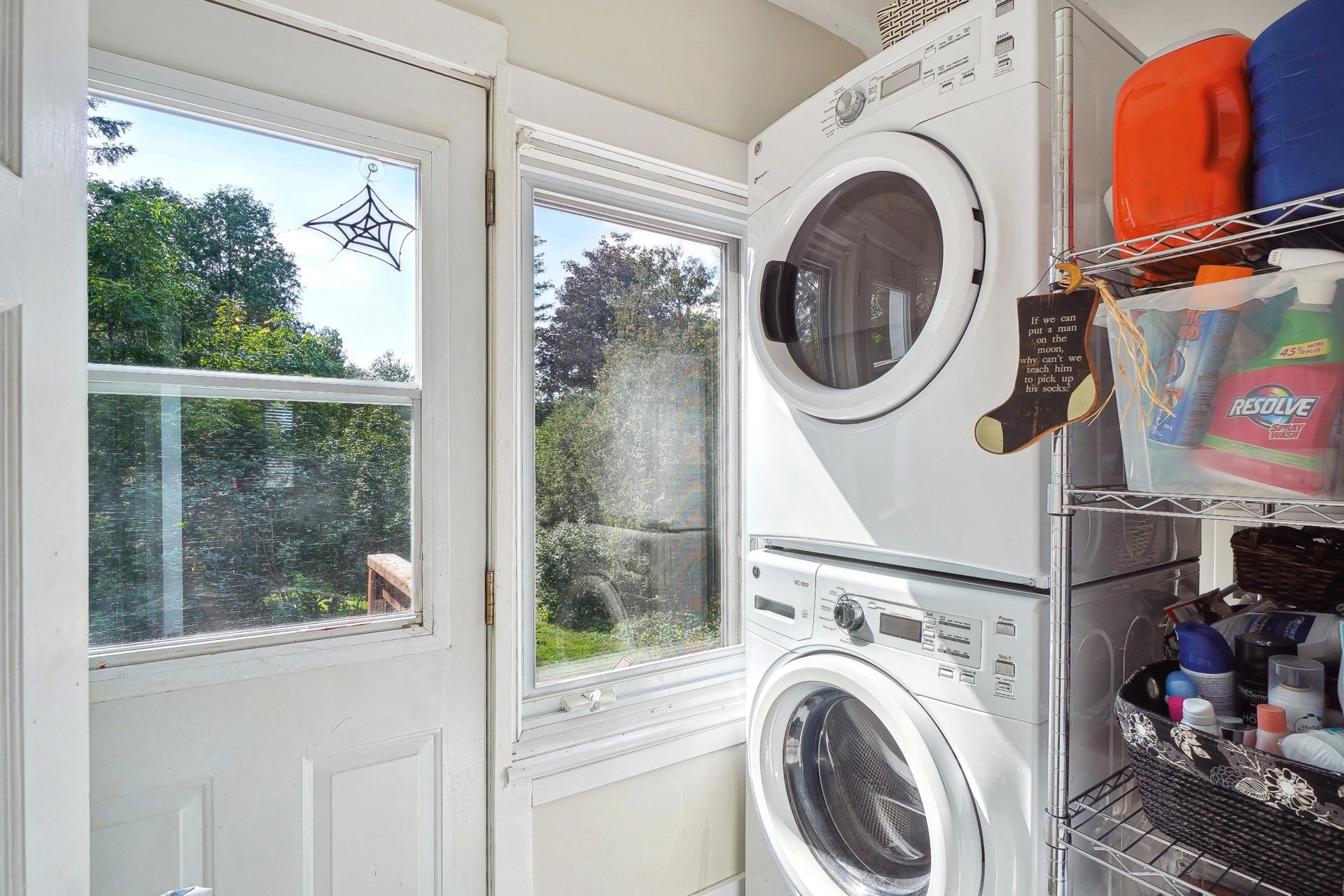 Bright laundry area with greenery views