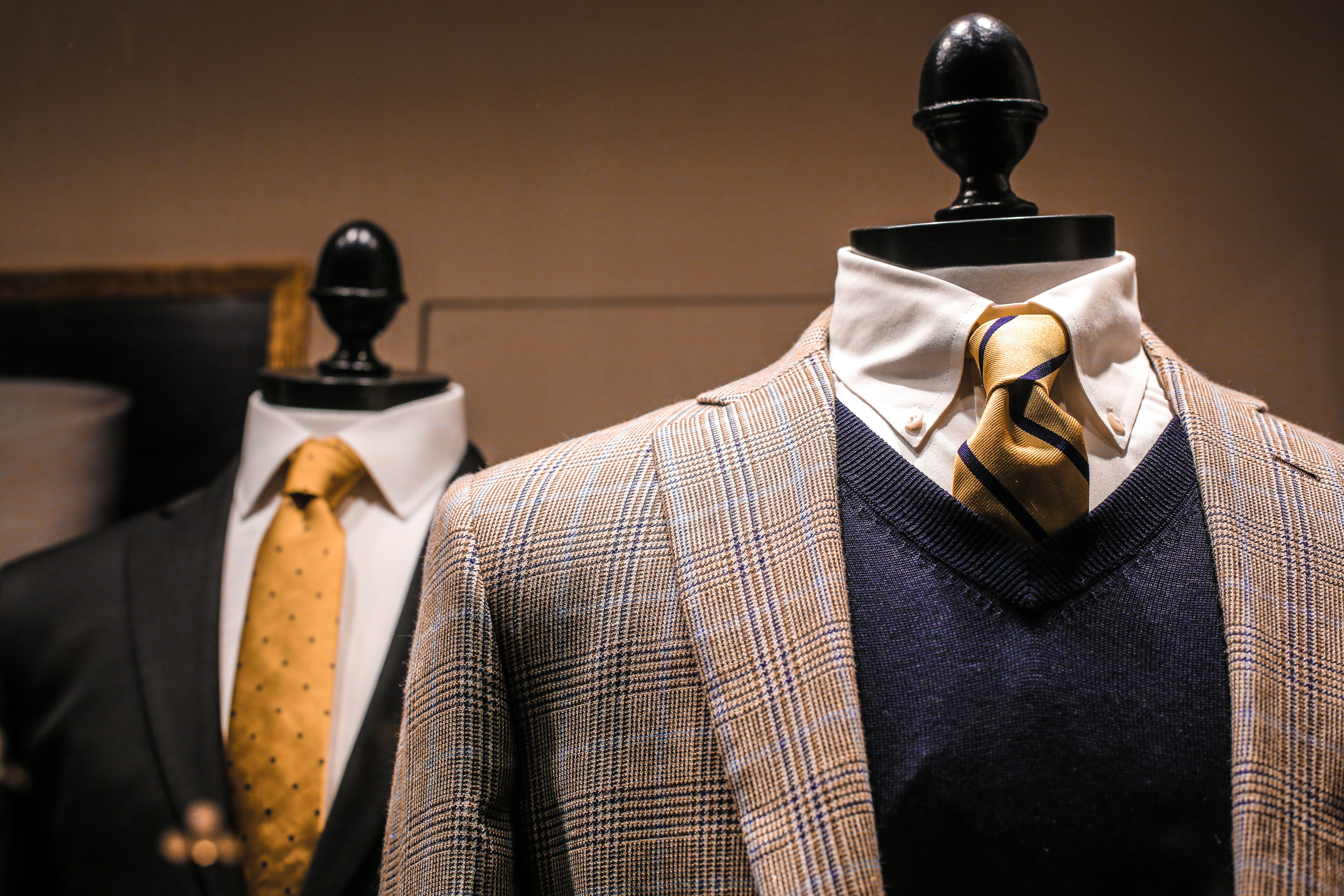 Free Dandy fancy jackets with shiny ties on dummies in showroom of contemporary male shop Stock Photo
