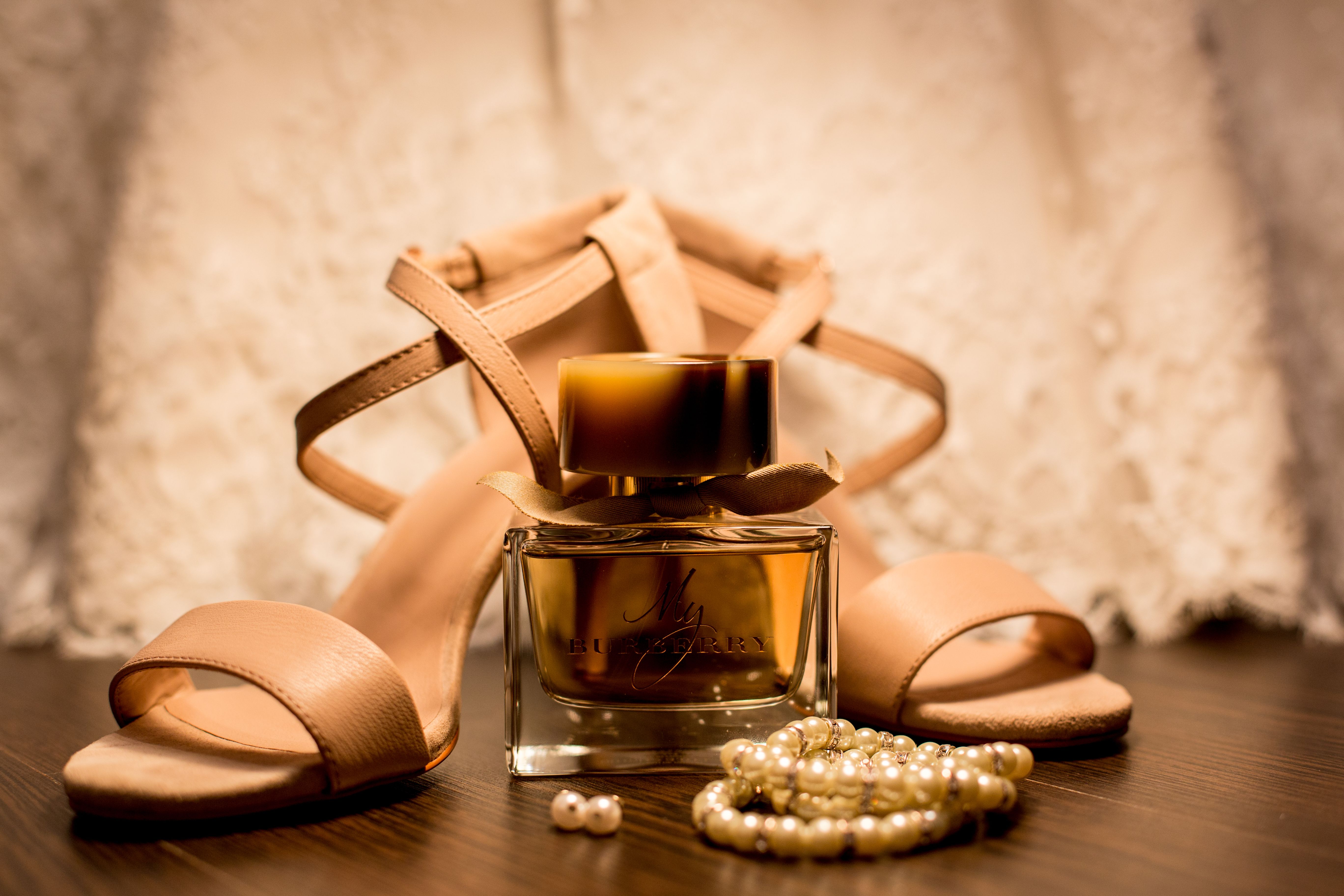Free Brown Glass Fragrance Bottle Beside White Pearl Bracelets Stock Photo