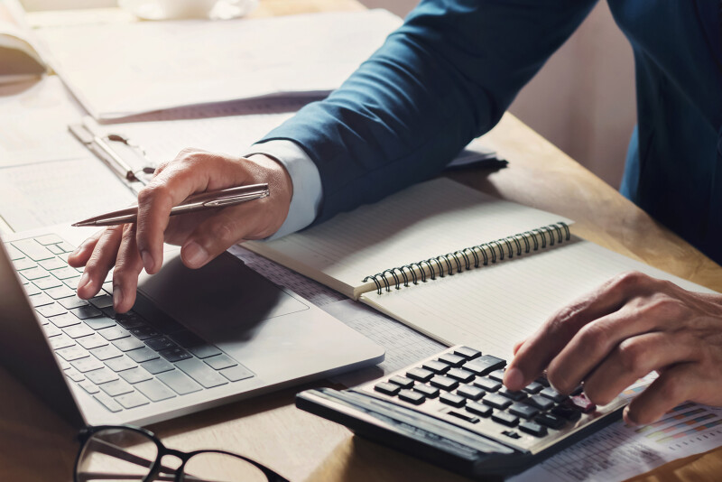 businessman-workig-using-calculator-with-laptop-desk.jpg