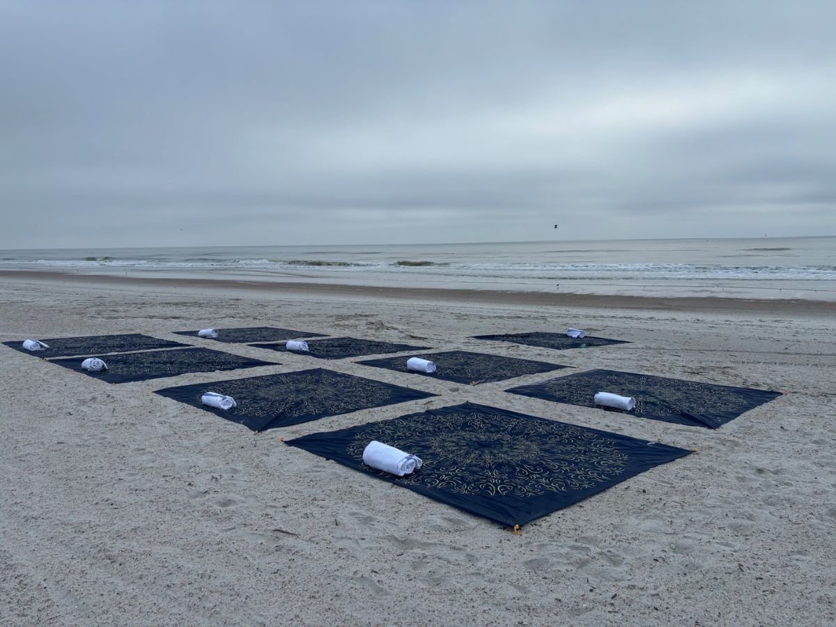 Yoga mats set up beautifully on the beach at sunrise