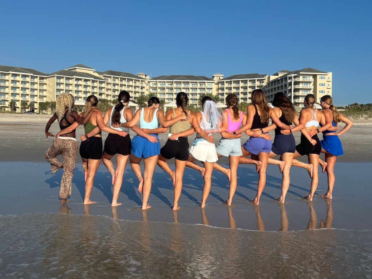 Group of women doing yoga on beach
