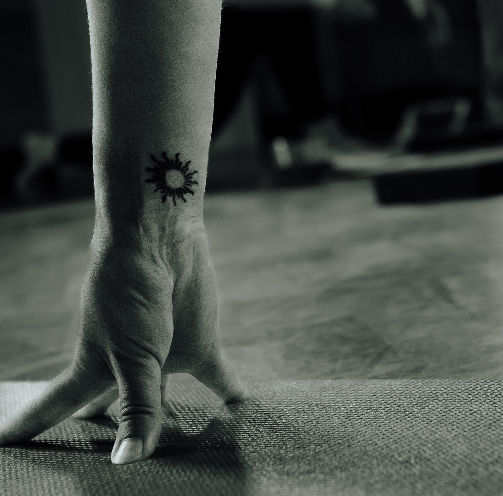 a student's hand preparing for downward facing dog