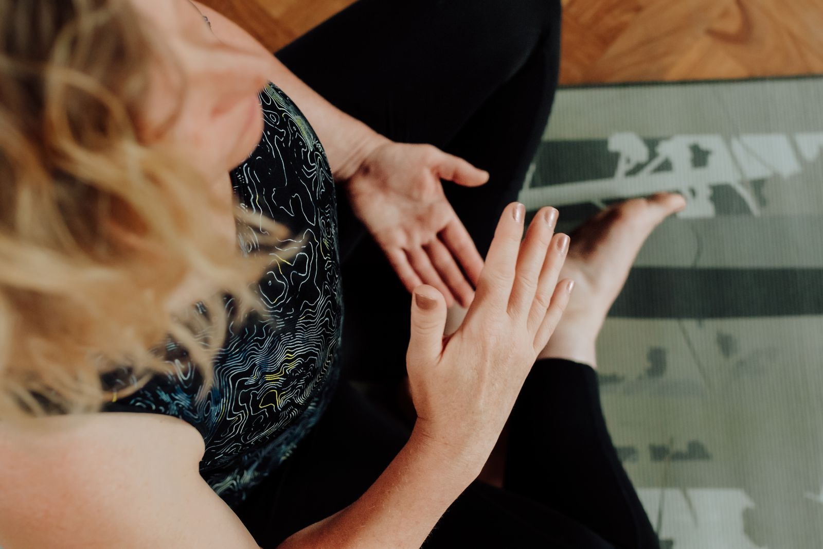 a woman in a 1:1 yoga session practicing diaphragmatic breathwork