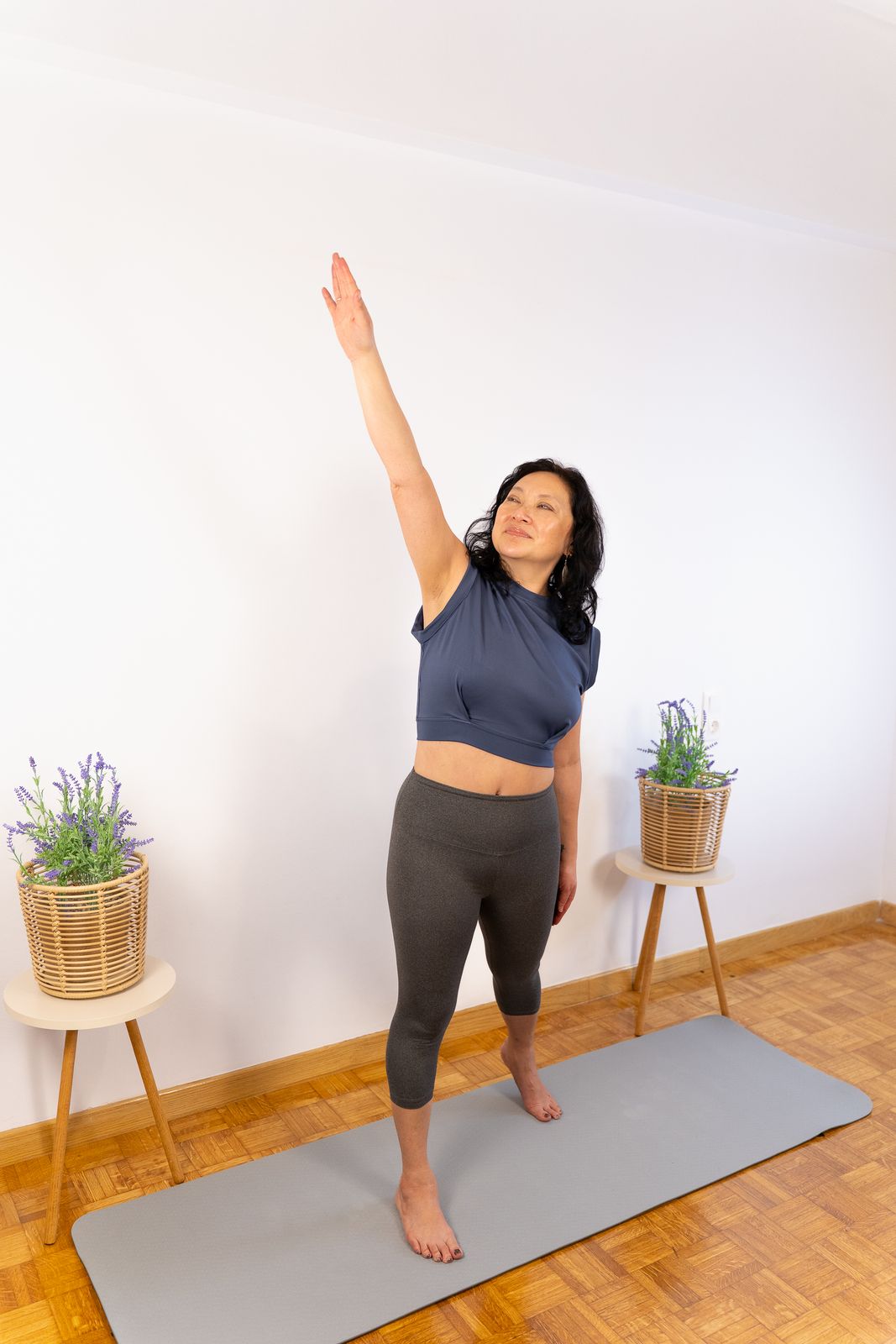Woman practicing gentle somatic yoga, part of a free 2-part workshop exploring somatic exercises to release trauma and support healing.