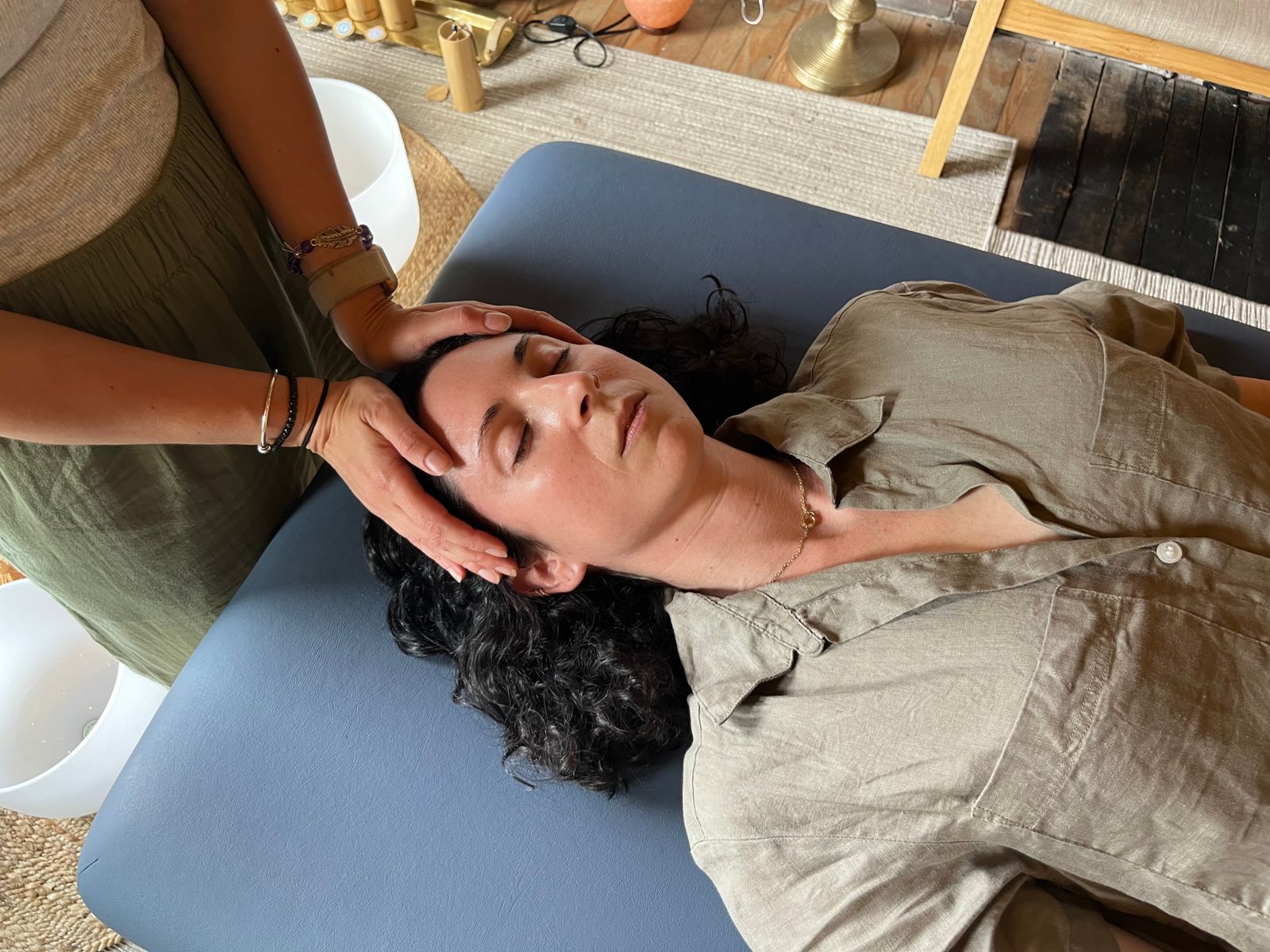 Close-up of a one-on-one Reiki healing session at Blue Jay Healing, with practitioner’s hands gently placed on a client’s head to support energy balance, stress relief, and emotional healing.