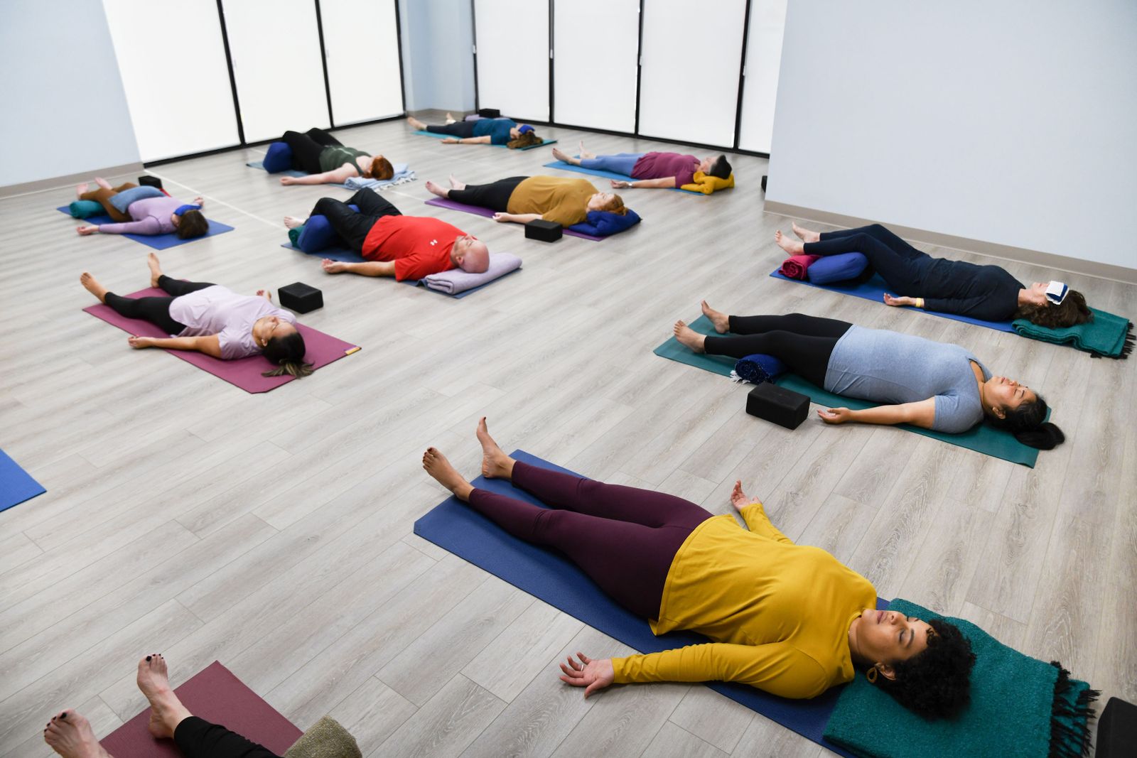 Yoga students in relaxation pose, Savasana