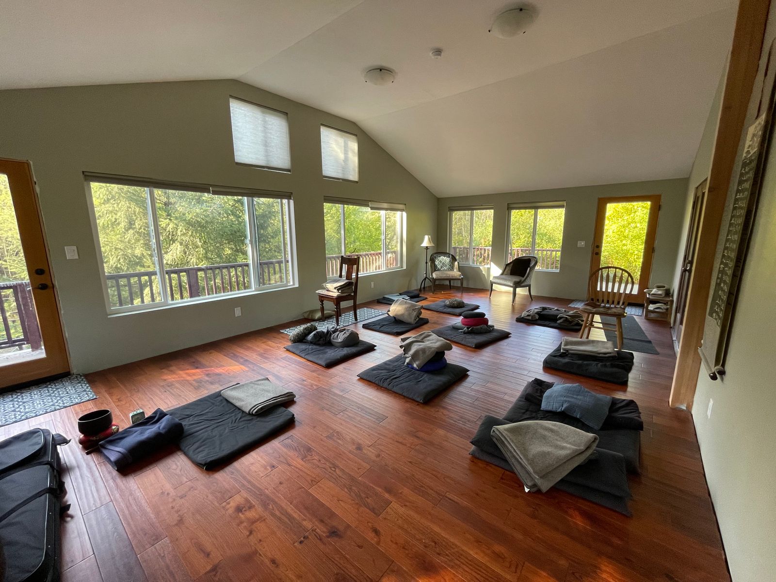 Meditation cushions in the main practice room surrounded by windows with beautiful forest views at a Taoist Cultivation Retreat