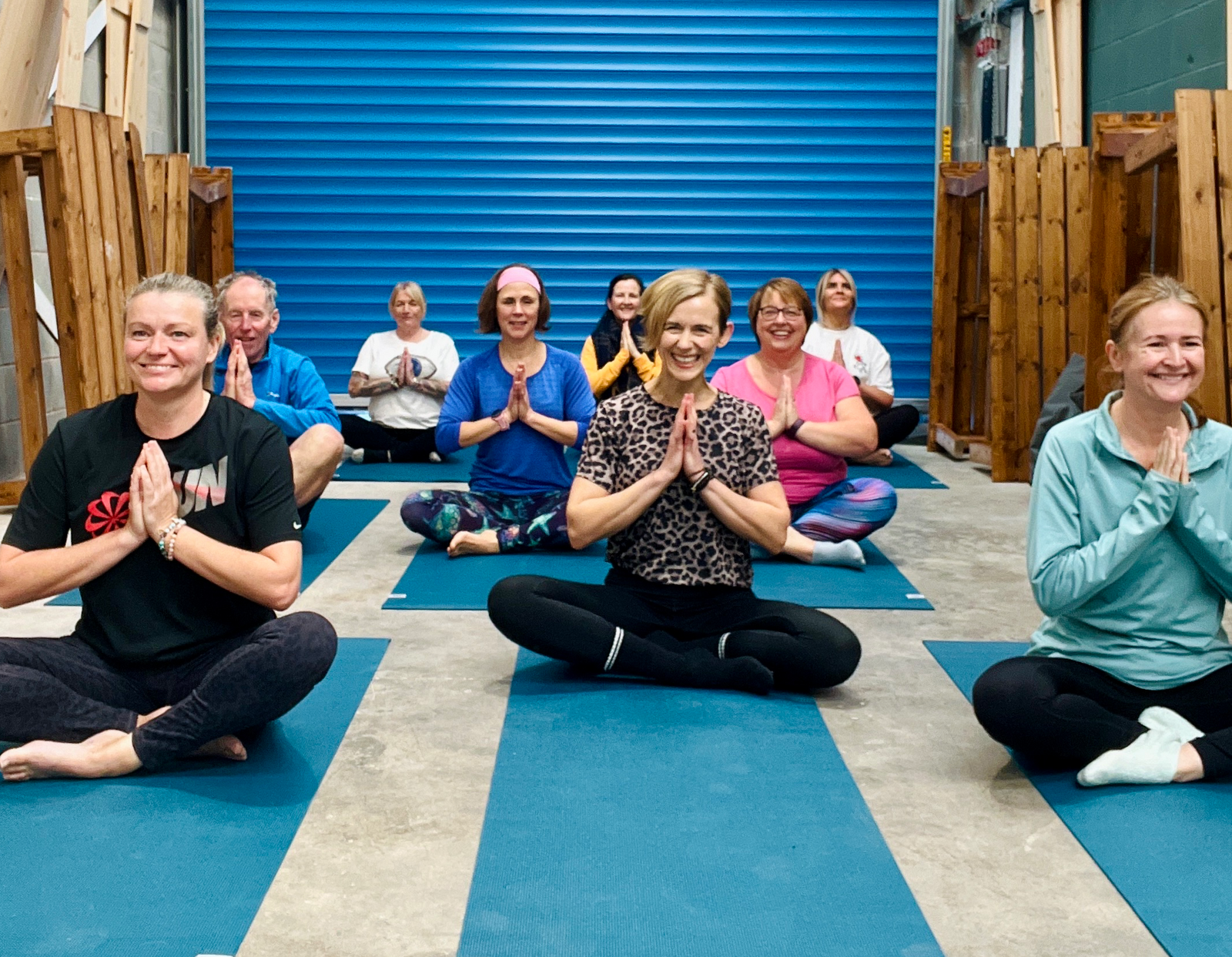 Paula teaching a yoga class full of smiling people