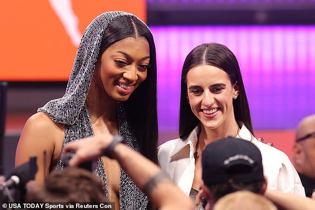 CLark smiles as she stands alongside Angel Reese ahead of the Draft in Brooklyn on Monday