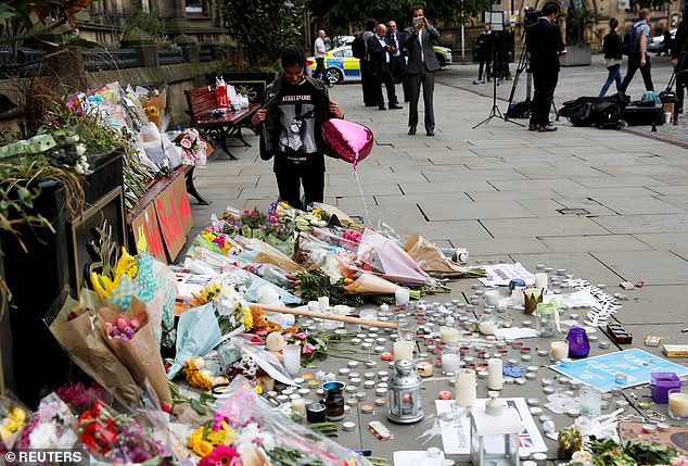 Floral tributes are seen lining the pavements at Manchester Arena in the aftermath of the concert