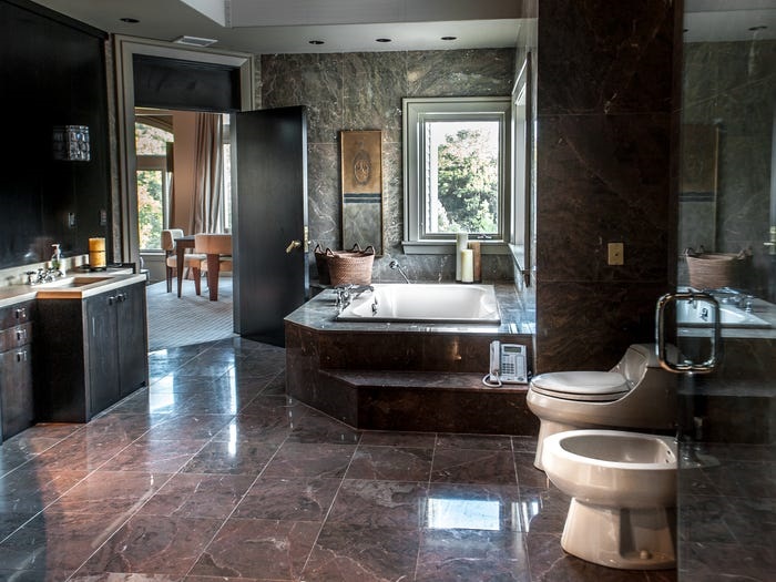  This bathroom features a huge bathtub overlooking the gardens