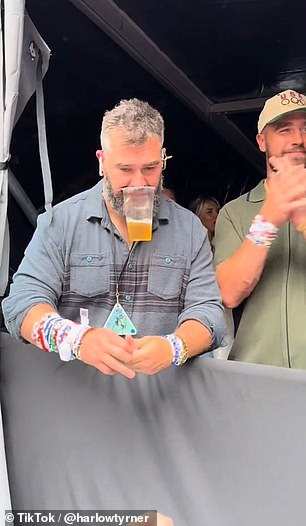 Kelce impressively held a beer with his mouth while showing off his countless amounts of bracelets