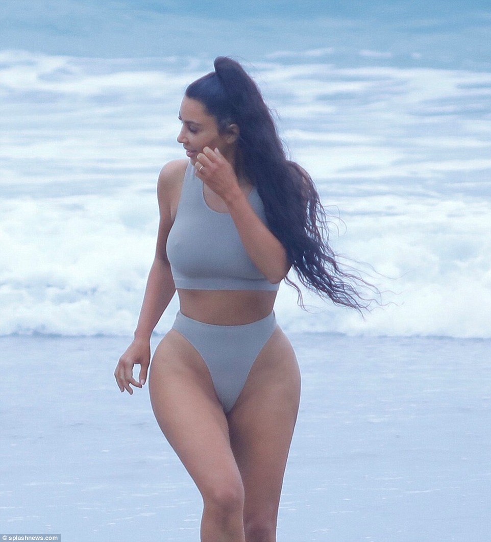 She always looks ready for a photo shoot: Kim posed just so as she ran up the beach; the star has been preparing for a new season of KUWTK which debuts this summer