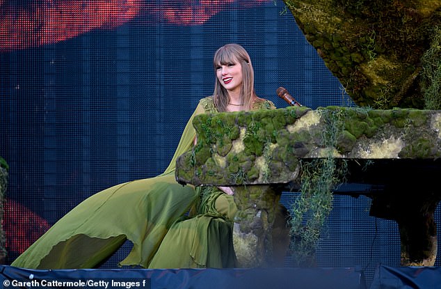 Taylor told fans the show was the biggest stadium performance in Scottish history - pictured here in a green dress she donned for her Folklore 'era'