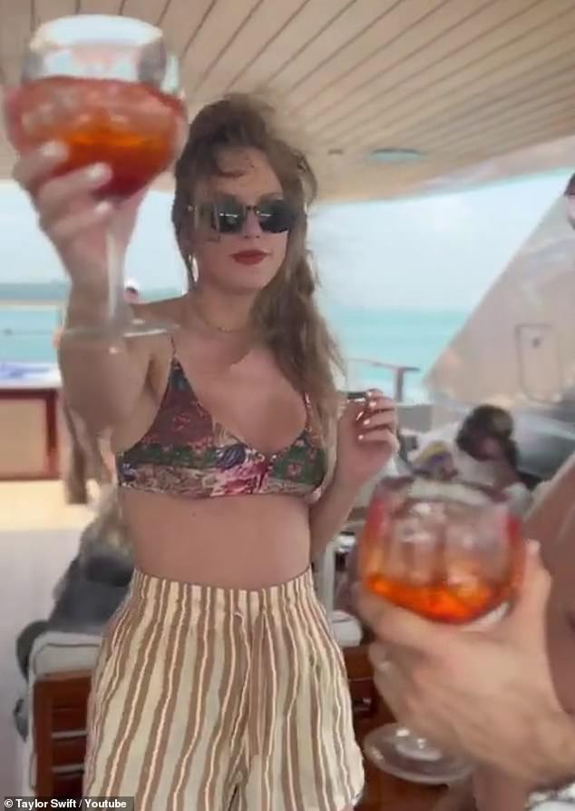 Will you join the singer's 14-day video challenge? To mark the Fortnight video's release, the singer also shared on YouTube Shorts 14 short video clips of her life during the past two weeks, including one of her enjoying a cocktail (pictured)