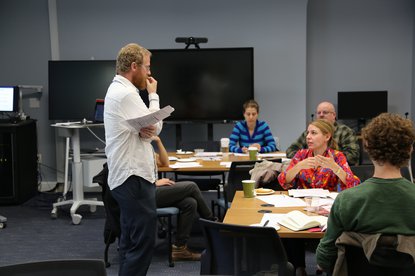 Professor conducting class listening