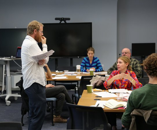 Professor conducting class listening